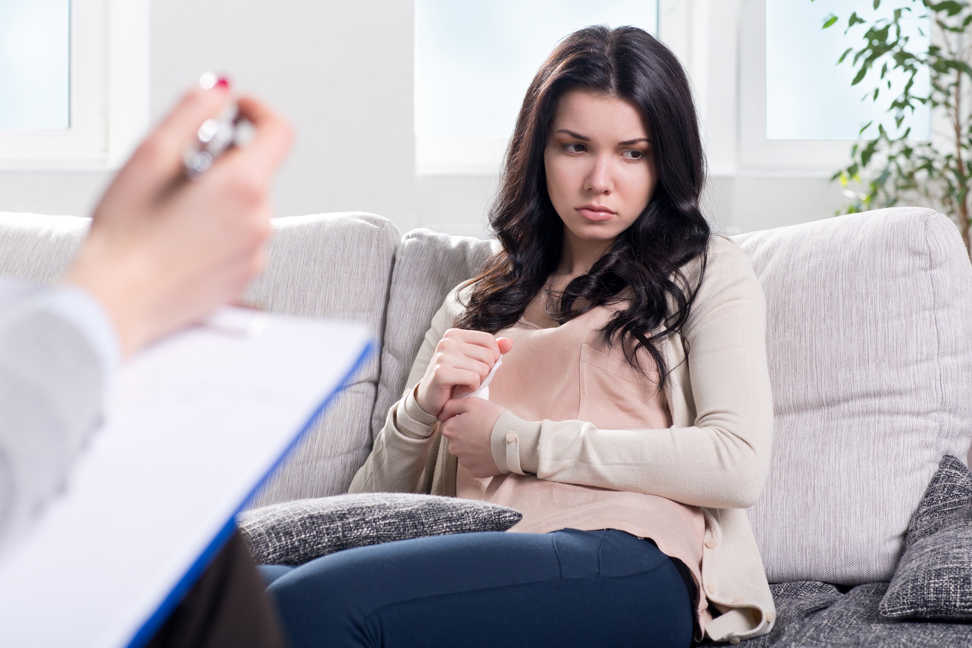 Depressed Young Woman on Couch at the Psychologist